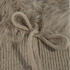Knit balaclava with plush long-pile trim, ribbed shoulder cape, and tie neckline.