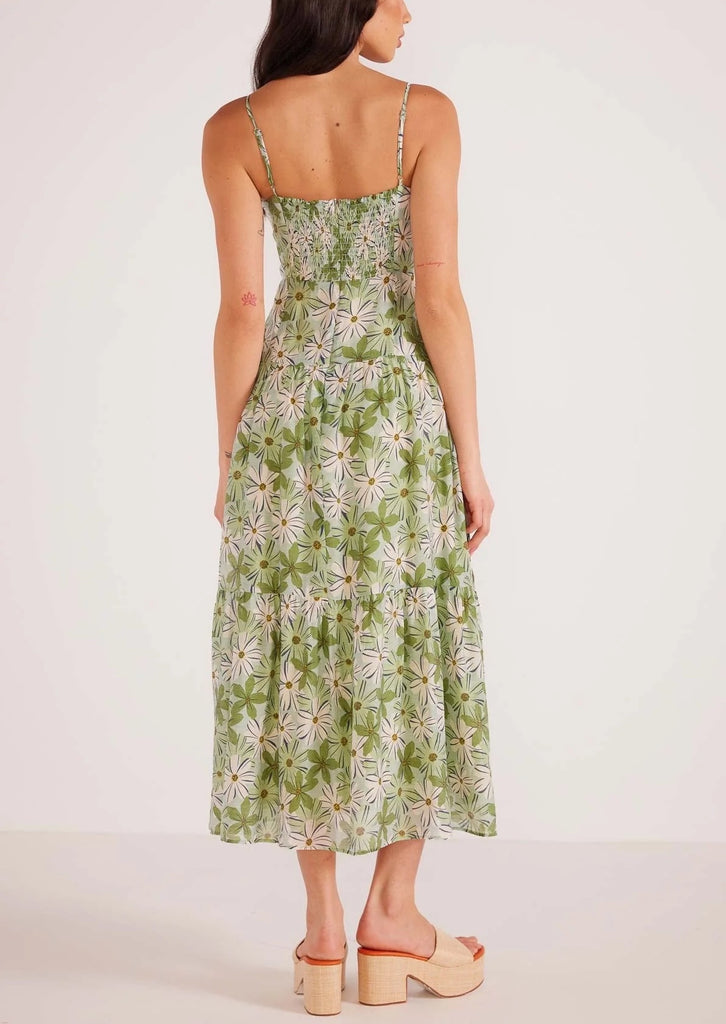 Margaux Maxi Dress Green White Floral. This tiered floral maxi dress features a straight neckline with thin adjustable straps, fitted bodice shirring through the back with an invisible zipper closure.