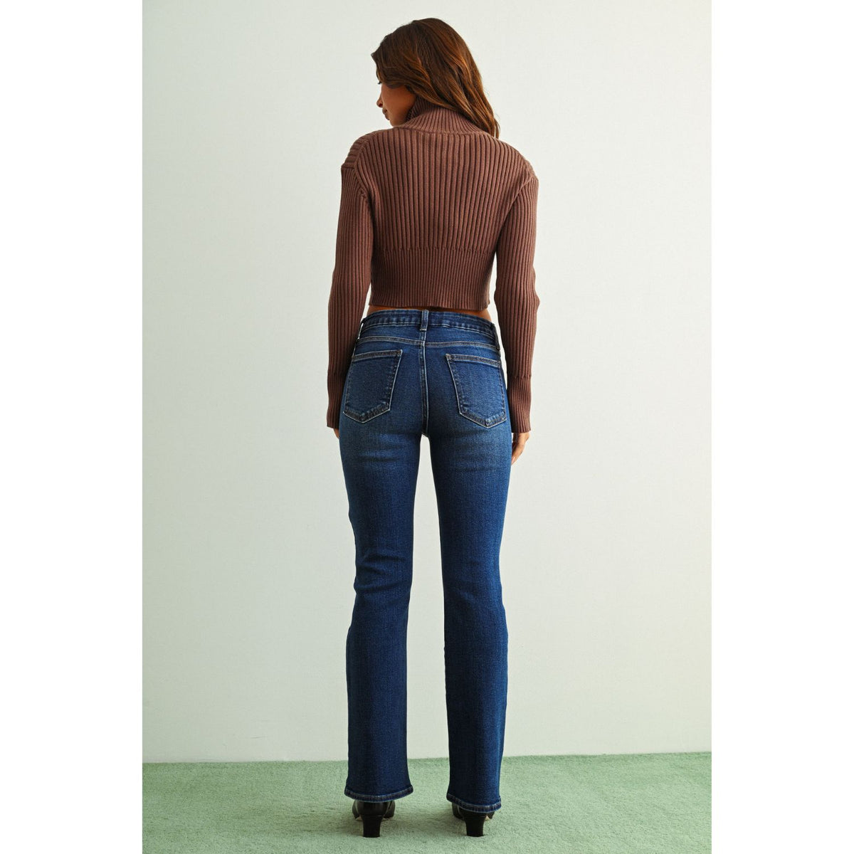 Mid-Rise Bootcut Jeans in a rich dark denim wash, featuring a flattering fit through the hips and thighs with a gently flared hem for a classic retro-inspired silhouette.