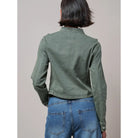 Military-inspired fitted denim jacket with a stand collar, decorative button tabs, and elbow patches