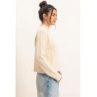 Moonbeam Mock Neck Sweater in cream with long sleeves, reversed seam detailing, and ribbed cuffs and hem.