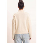 Moonbeam Mock Neck Sweater in cream with long sleeves, reversed seam detailing, and ribbed cuffs and hem.
