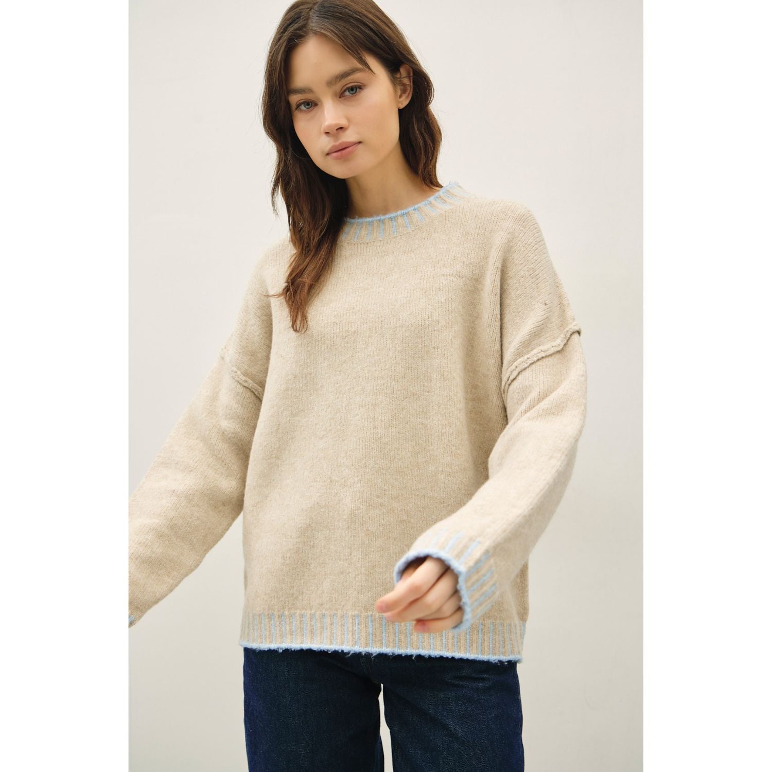 Women's oversized mock neck sweater with dropped shoulders, contrast stitching accents, and a relaxed fit