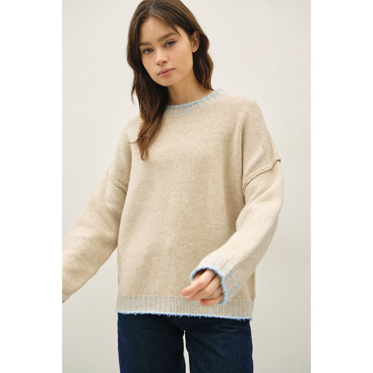 Women's oversized mock neck sweater with dropped shoulders, contrast stitching accents, and a relaxed fit