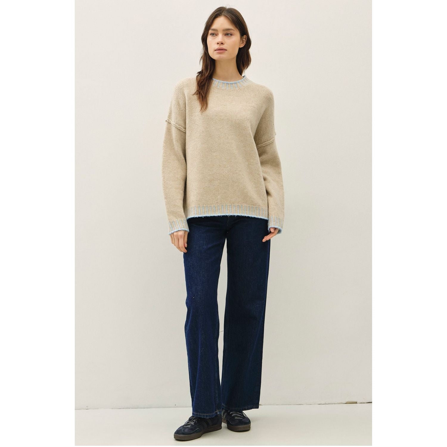 Women's oversized mock neck sweater with dropped shoulders, contrast stitching accents, and a relaxed fit