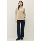 Women's oversized mock neck sweater with dropped shoulders, contrast stitching accents, and a relaxed fit