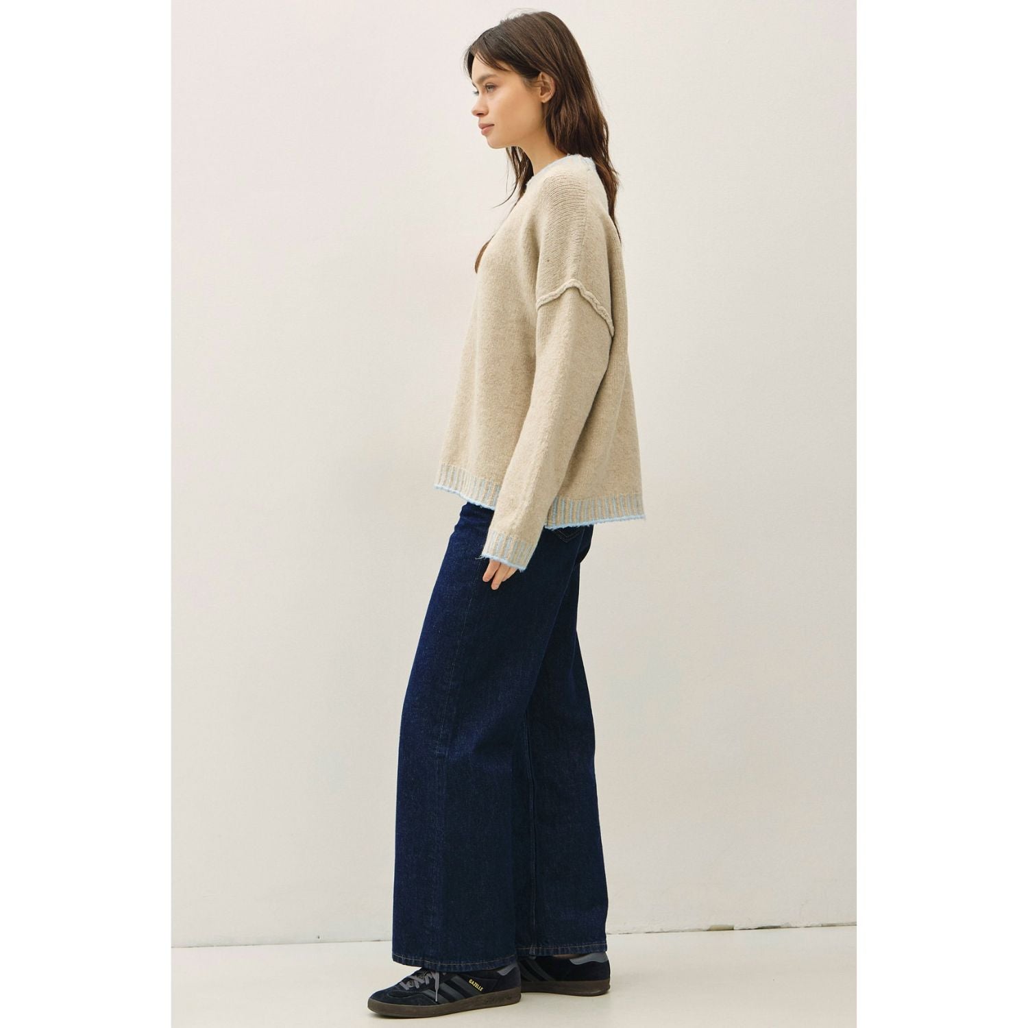Women's oversized mock neck sweater with dropped shoulders, contrast stitching accents, and a relaxed fit