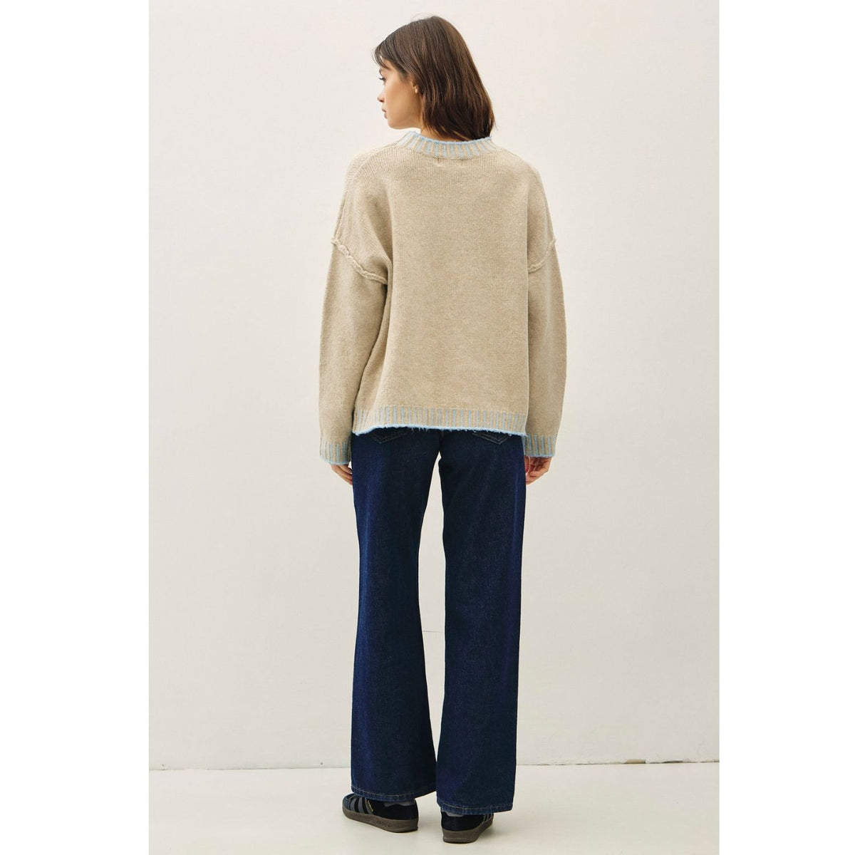 Women's oversized mock neck sweater with dropped shoulders, contrast stitching accents, and a relaxed fit
