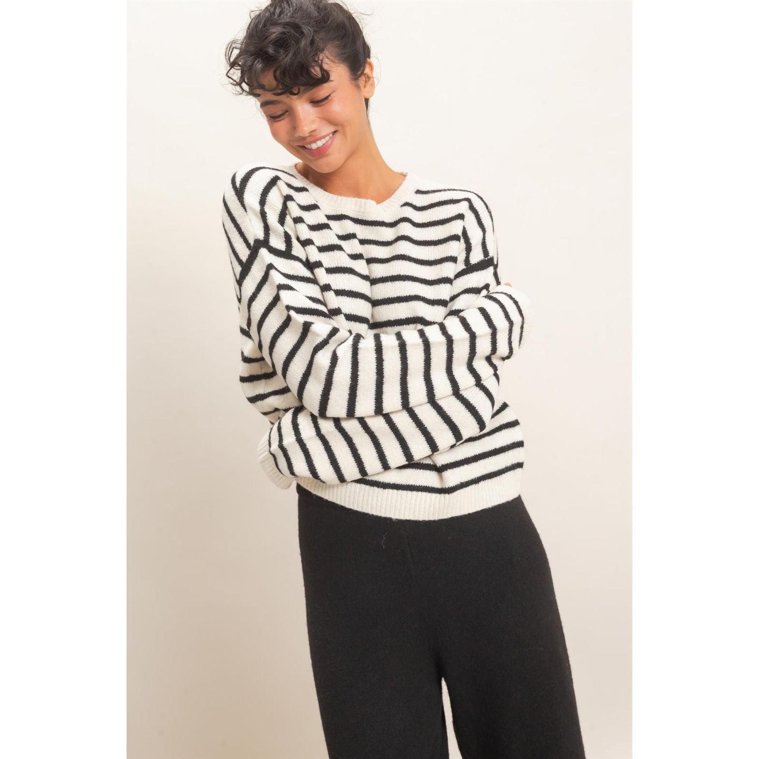 Model wearing Moonbeam Stripe Cozy Crewneck Sweater with black stripes, featuring a relaxed fit and ribbed trims