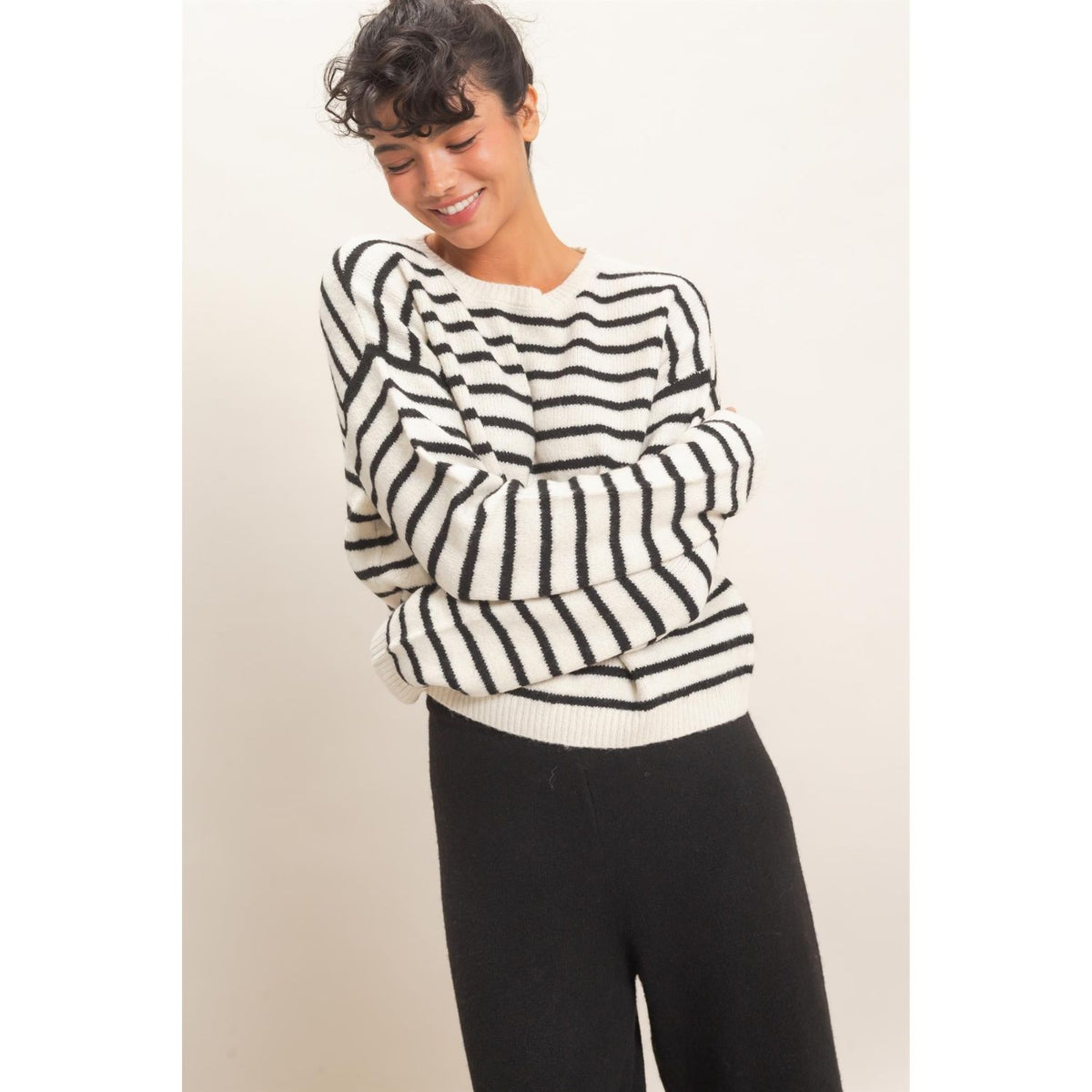 Model wearing Moonbeam Stripe Cozy Crewneck Sweater with black stripes, featuring a relaxed fit and ribbed trims