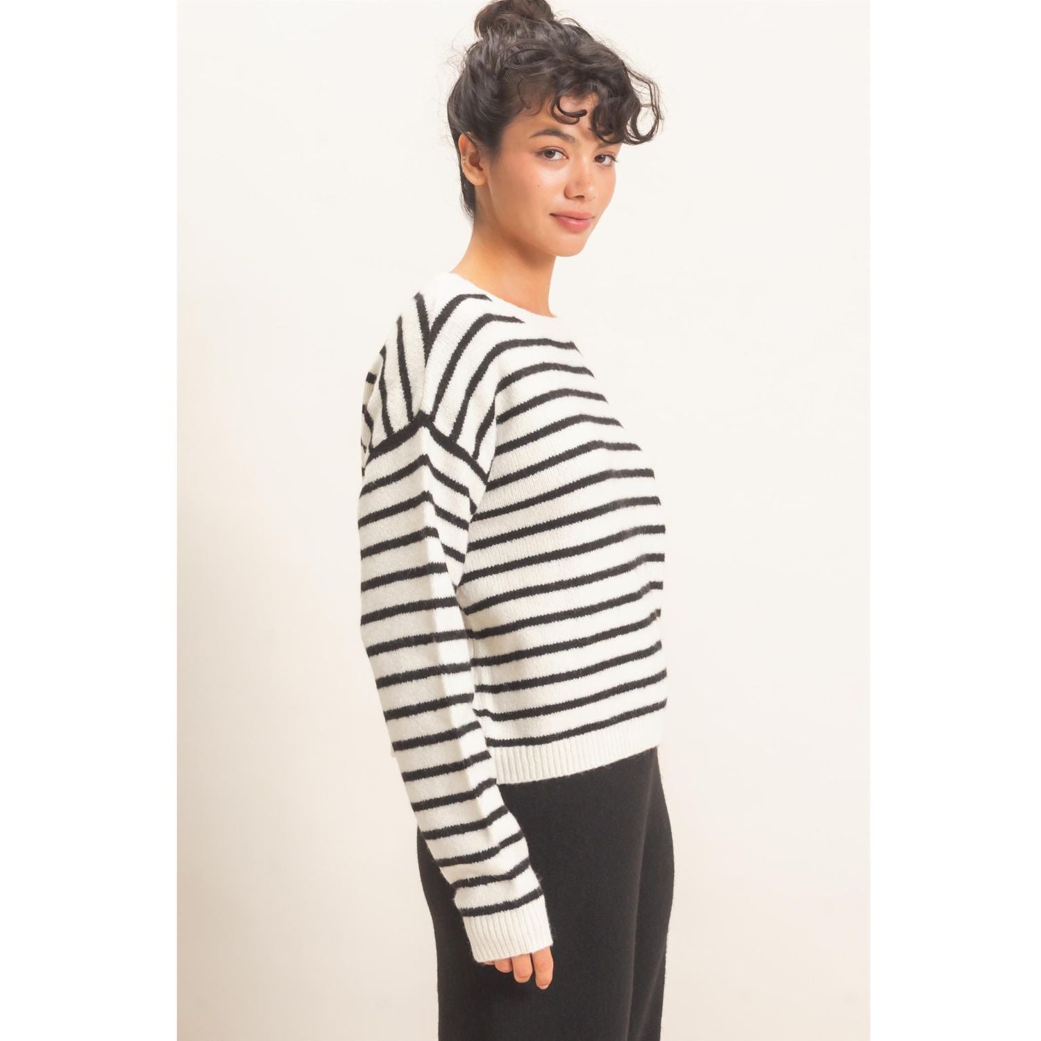 Model wearing Moonbeam Stripe Cozy Crewneck Sweater with black stripes, featuring a relaxed fit and ribbed trims