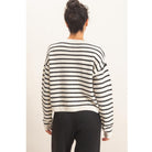 Model wearing Moonbeam Stripe Cozy Crewneck Sweater with black stripes, featuring a relaxed fit and ribbed trims