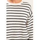 Model wearing Moonbeam Stripe Cozy Crewneck Sweater with black stripes, featuring a relaxed fit and ribbed trims