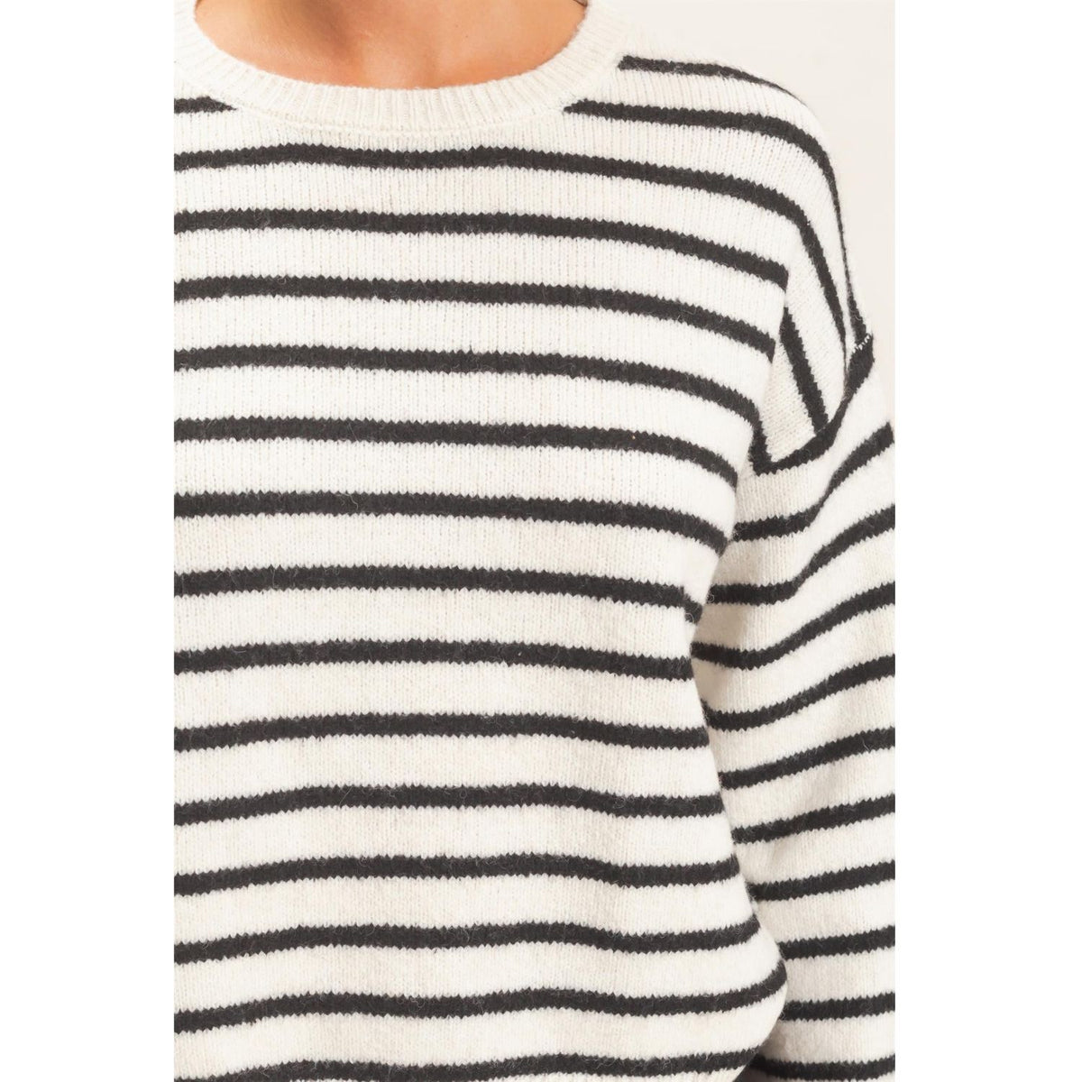 Model wearing Moonbeam Stripe Cozy Crewneck Sweater with black stripes, featuring a relaxed fit and ribbed trims