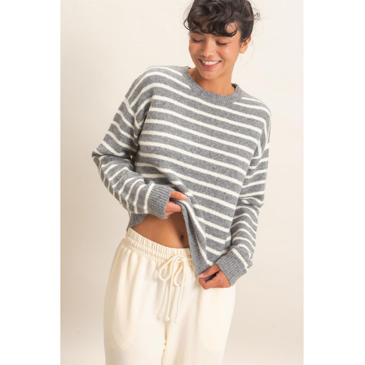 Model wearing Moonbeam Stripe Cozy Crewneck Sweater with black stripes, featuring a relaxed fit and ribbed trims