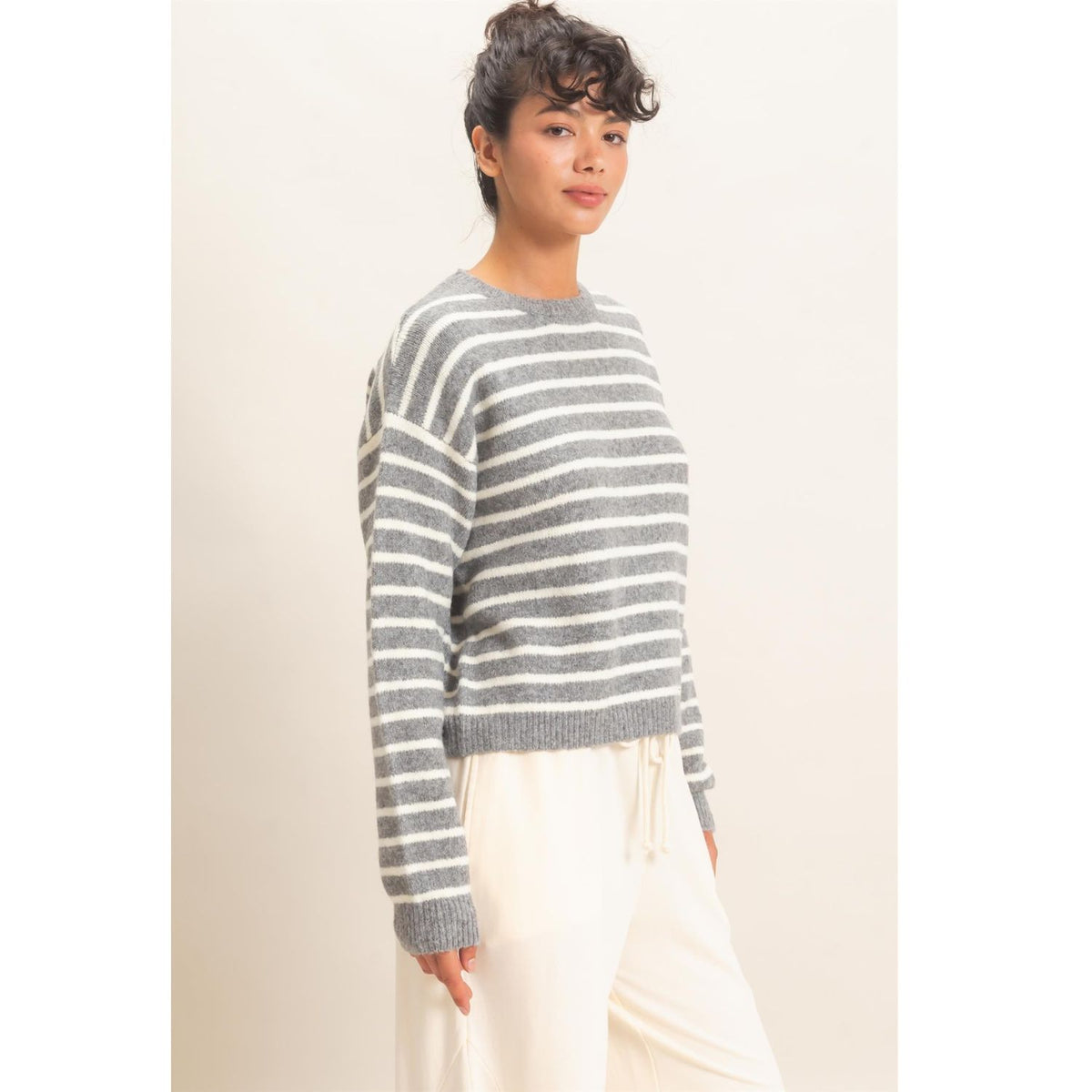 Model wearing Moonbeam Stripe Cozy Crewneck Sweater with black stripes, featuring a relaxed fit and ribbed trims