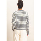 Model wearing Moonbeam Stripe Cozy Crewneck Sweater with black stripes, featuring a relaxed fit and ribbed trims