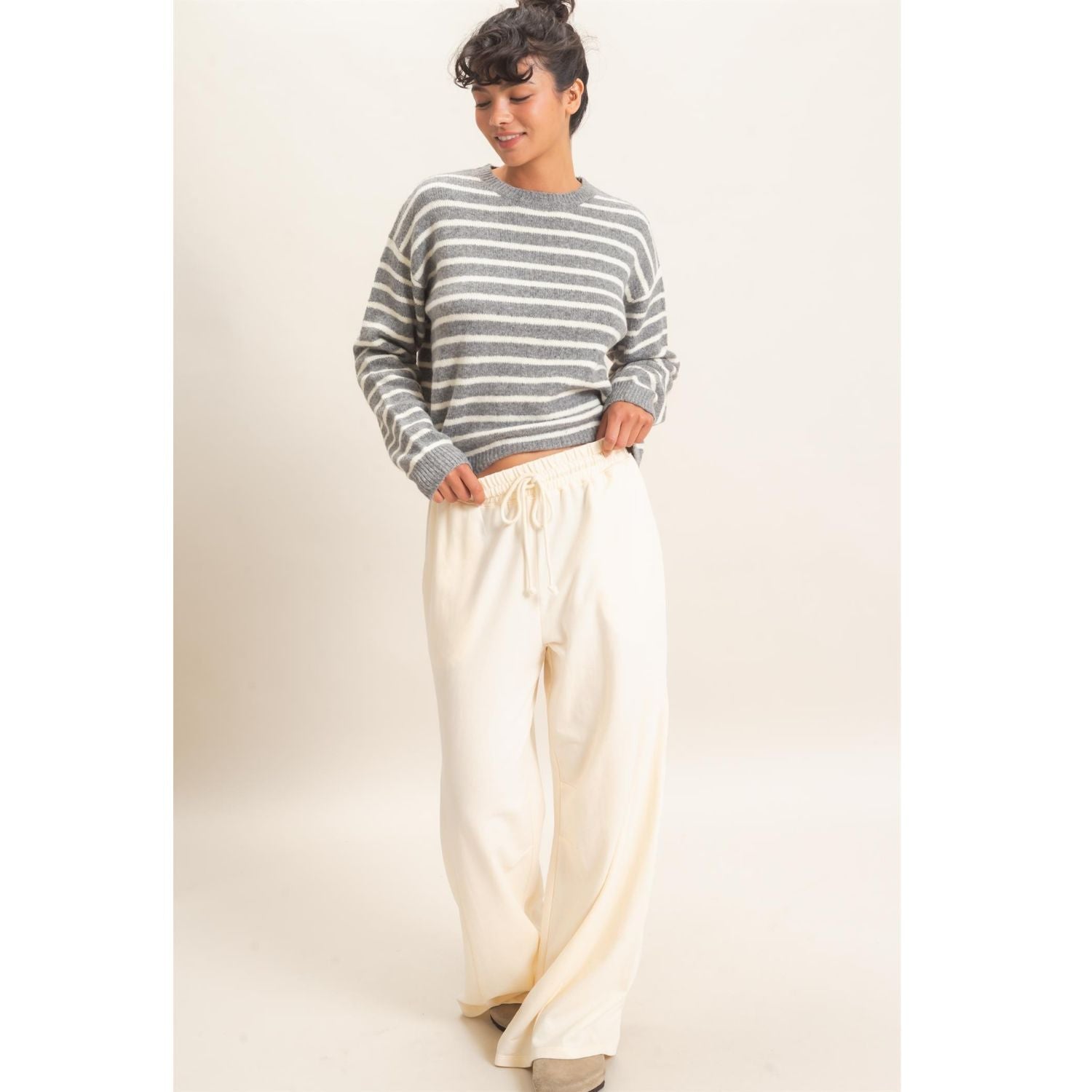 Model wearing Moonbeam Stripe Cozy Crewneck Sweater with black stripes, featuring a relaxed fit and ribbed trims