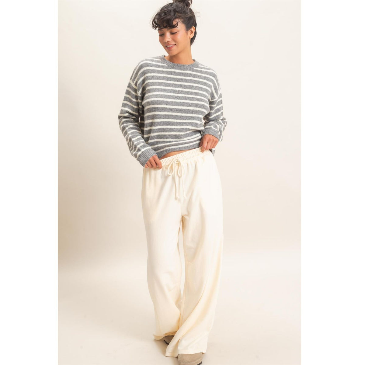 Model wearing Moonbeam Stripe Cozy Crewneck Sweater with black stripes, featuring a relaxed fit and ribbed trims