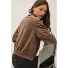 Women's suede-feel bomber jacket with a high collar, zipper and snap-button front, welt pockets, and banded hem