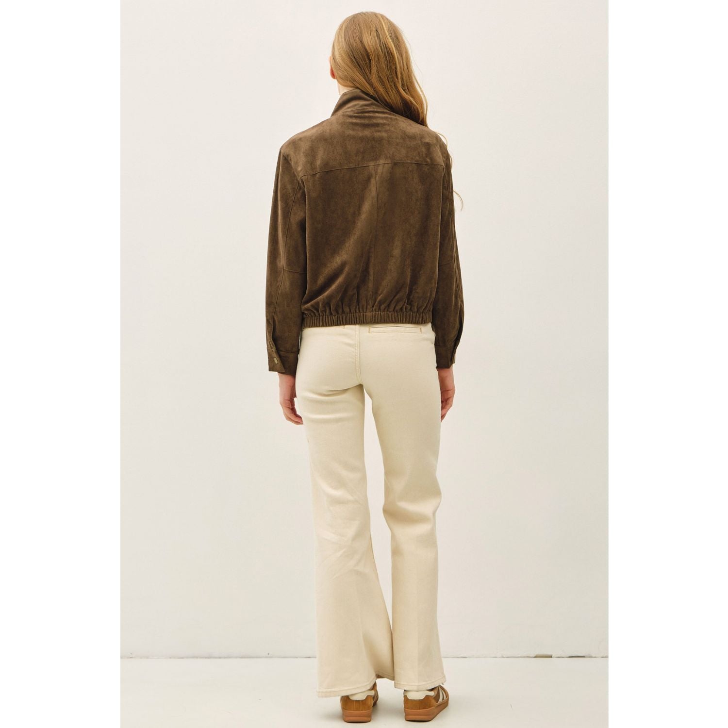 Women's suede-feel bomber jacket with a high collar, zipper and snap-button front, welt pockets, and banded hem