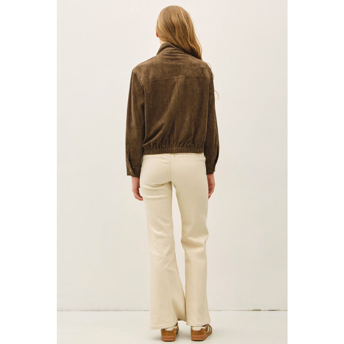 Women's suede-feel bomber jacket with a high collar, zipper and snap-button front, welt pockets, and banded hem