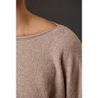 Women's heathered boat neck knit sweater with long sleeves, ribbed cuffs, rolled-edge details, and a relaxed fit