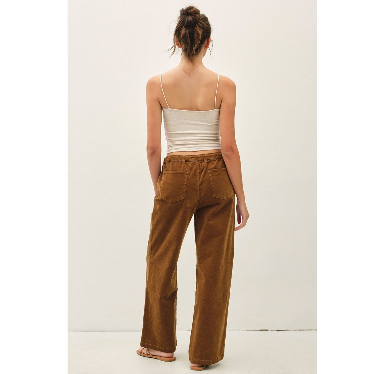 Women's wide-leg corduroy pants with a textured finish, elastic waistband, relaxed fit, and functional pockets