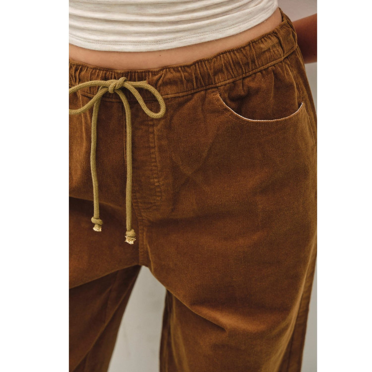 Women's wide-leg corduroy pants with a textured finish, elastic waistband, relaxed fit, and functional pockets