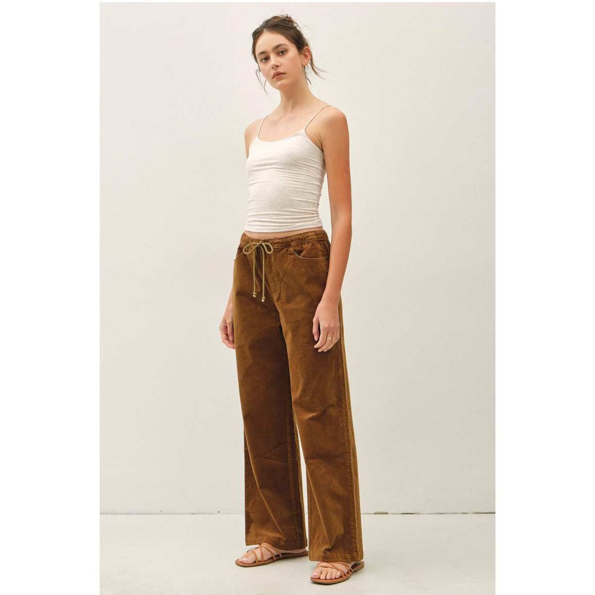 Women's wide-leg corduroy pants with a textured finish, elastic waistband, relaxed fit, and functional pockets