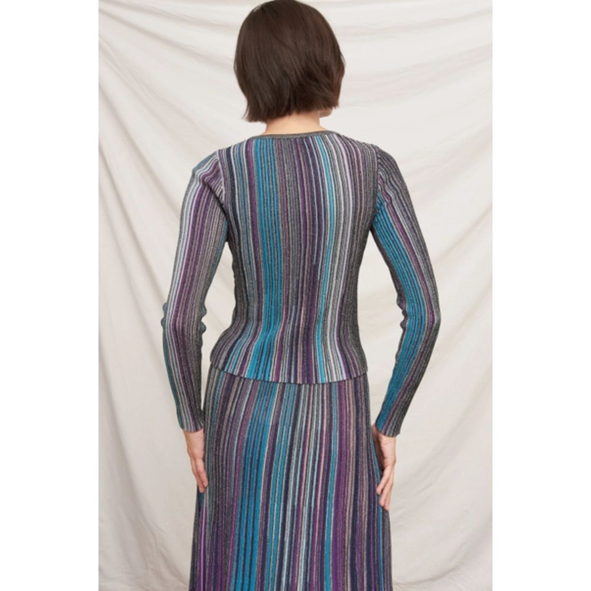 Fitted multicolor striped ribbed knit top with metallic shimmer, split neckline, and long sleeves.