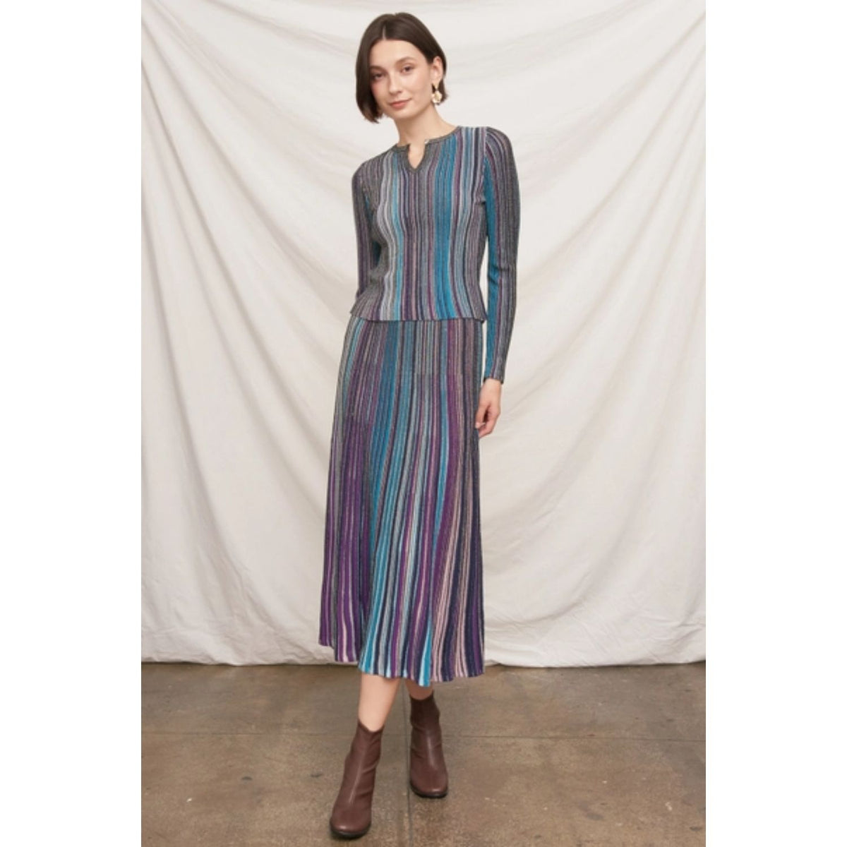 Fitted multicolor striped ribbed knit top with metallic shimmer, split neckline, and long sleeves.