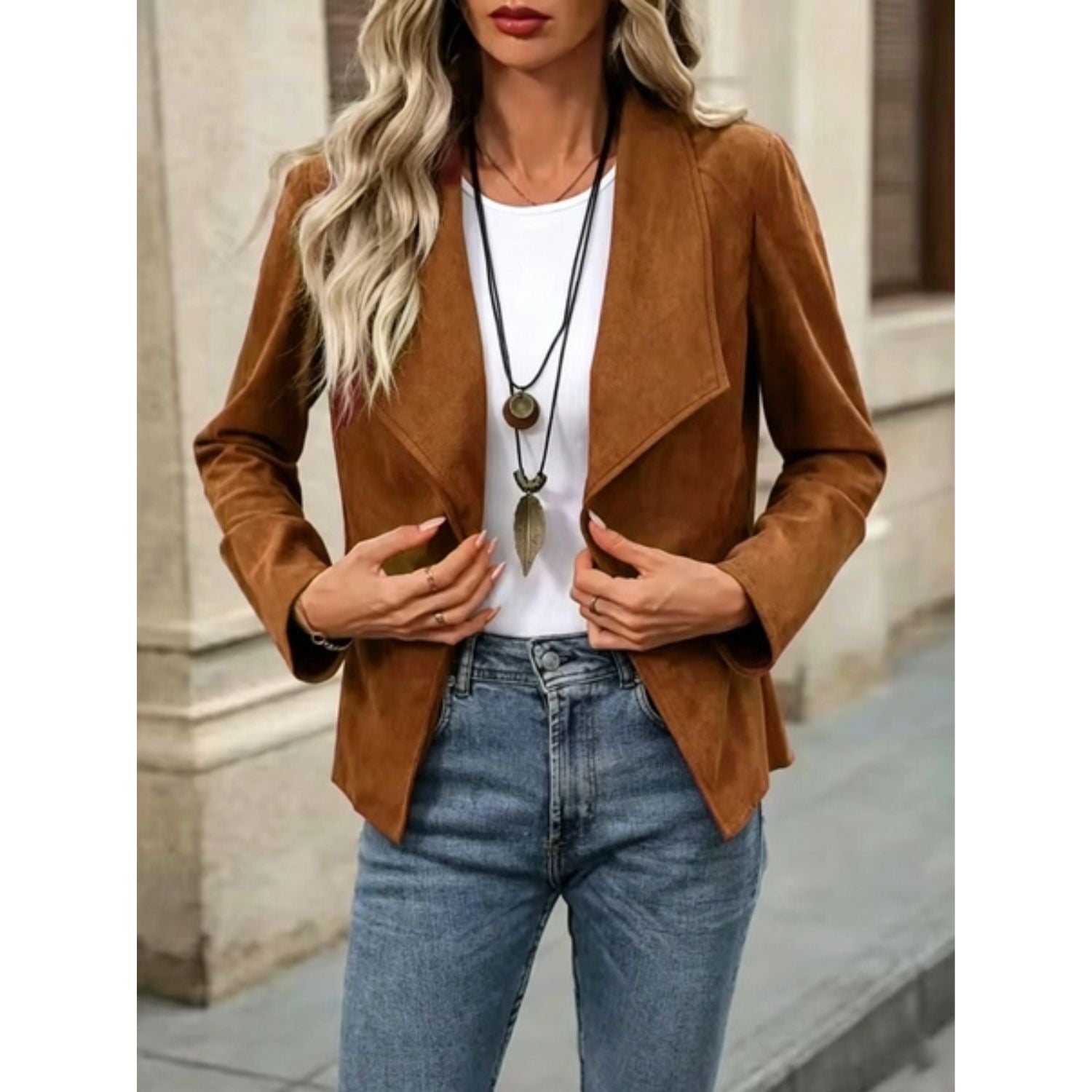 Faux suede jacket with an open front, draped lapel, and long sleeves.