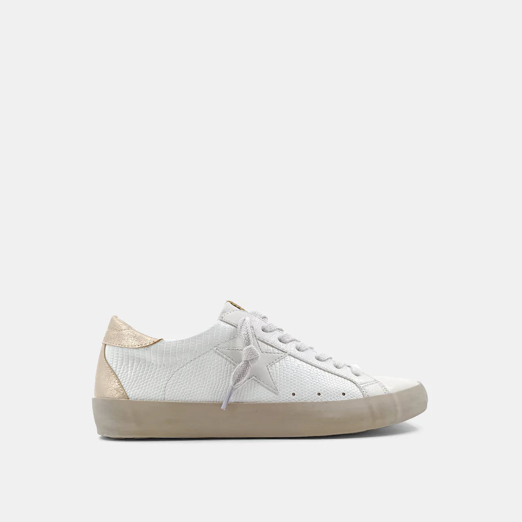 Paula Sneaker Bone Lizard. With its round toe and sturdy sole,these sneaker are a modern classic inspired by vintage styles. Its neutral color combination will work perfectly with your outfit.