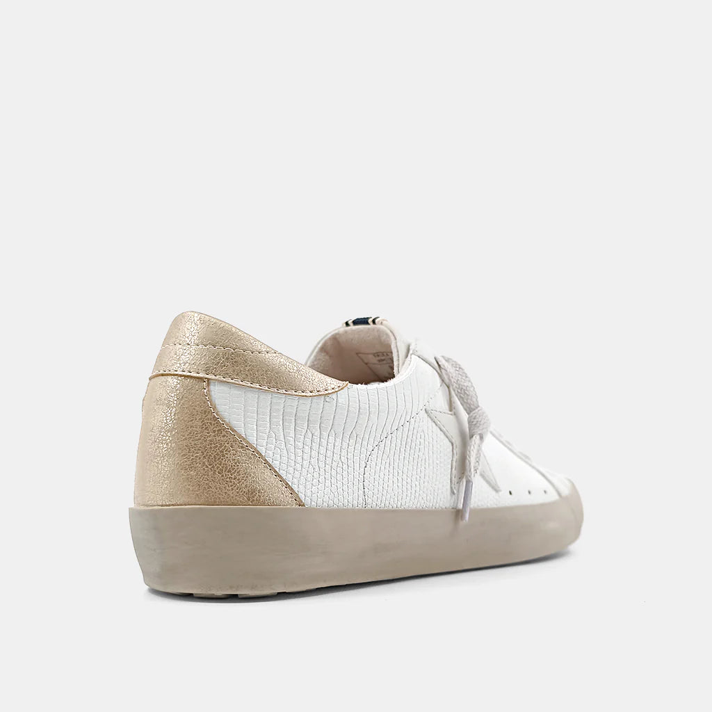 Paula Sneaker Bone Lizard. With its round toe and sturdy sole,these sneaker are a modern classic inspired by vintage styles. Its neutral color combination will work perfectly with your outfit.