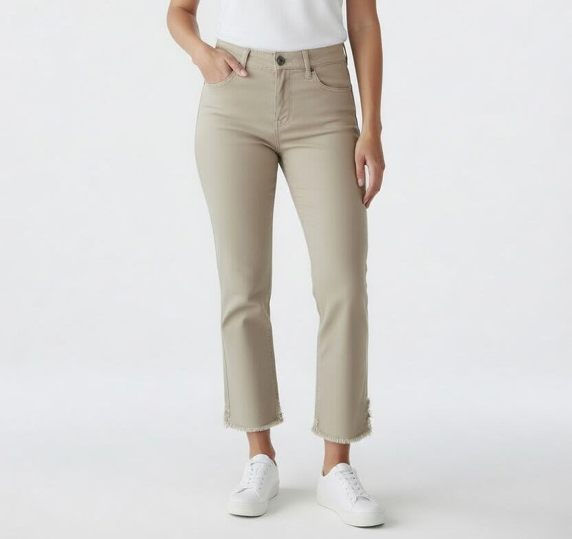 Woman wearing cropped straight leg beige denim jeans with a frayed hem styled with a fitted tee and sneakers