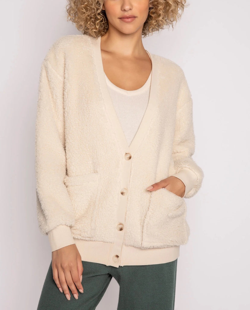 PJ Salvage Shearling Cardigan Oatmeal. Every chilly season deserves a versatile, wear-anywhere cardigan sweater. We love this faux-furry button up cardigan with patch pockets. Inside graphic delivers a smile every time you wear it.