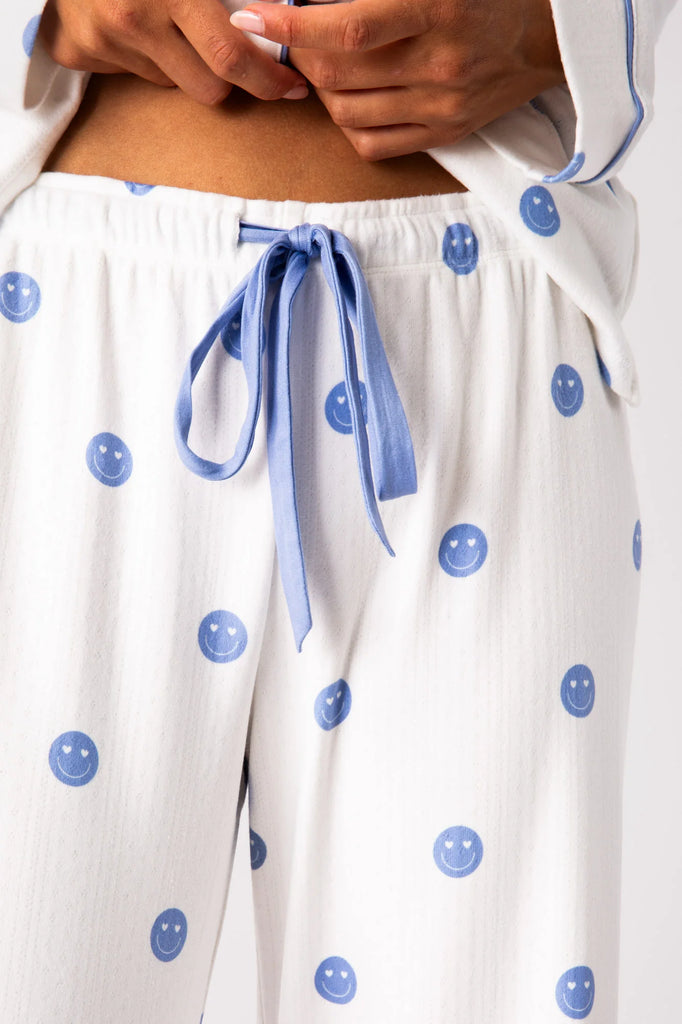Get comfy in the happiest pajama set he season, made with subtle textured pointelle in double brushed (double-soft!) knit with fun smiling emojis, featuring a tie elastic waist.