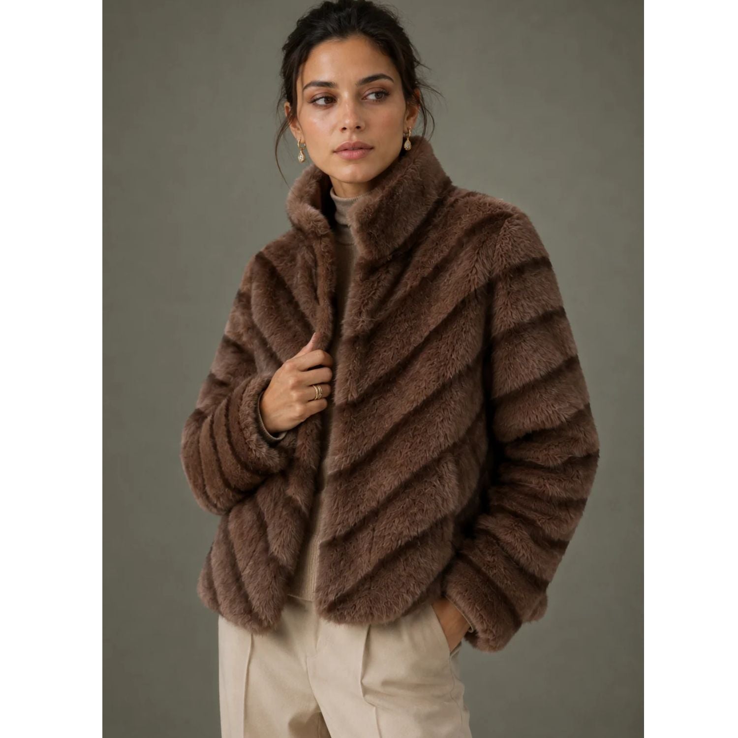 Reversible Fur Jacket in rich brown featuring a plush textured finish, elegant high collar, diagonal fur panel detailing, and a relaxed hip-length silhouette