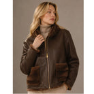 Reversible Fur Jacket in rich brown featuring a plush textured finish, elegant high collar, diagonal fur panel detailing, and a relaxed hip-length silhouette