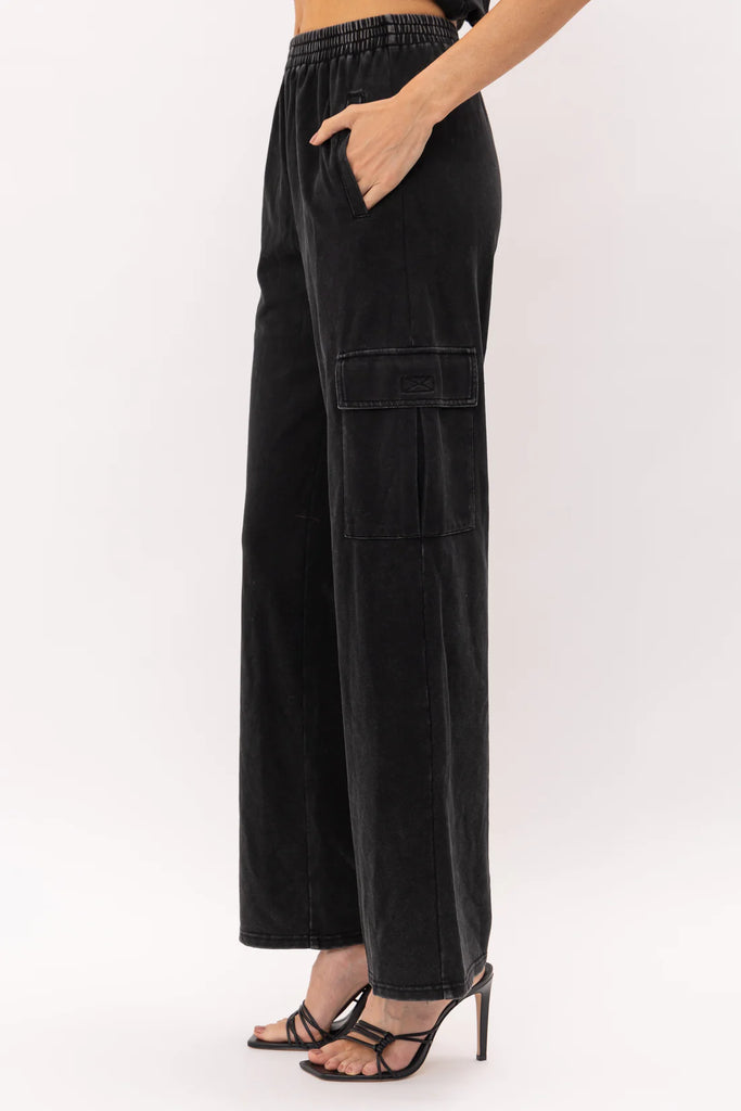 Remi Utility Pant Black. These utility pants feature an elastic waist band with cargo style pocks and a straight leg fit, wear them on their own or as a set with the Remi Bustier Top.