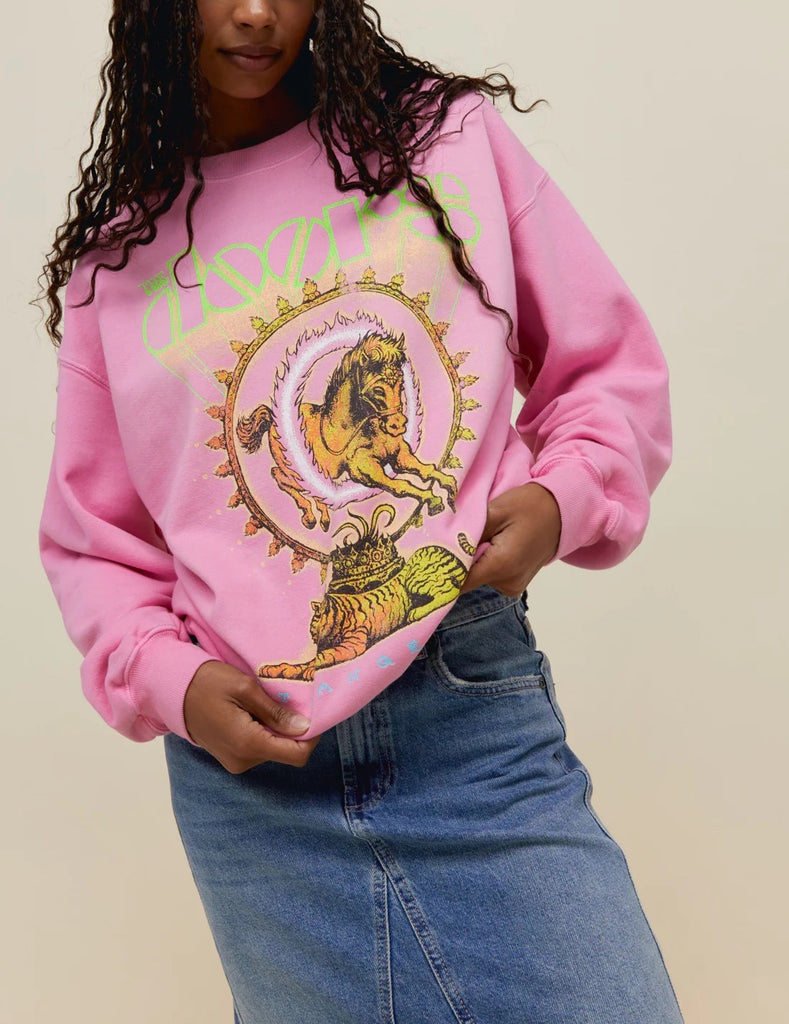 Day Dreamer The Doors Crewneck Pink Sugar. This boyfriend crewneck pays tribute to The Doors’ lasting legacy with 100% original artwork of a horse and tiger graphic mixed with psychedelic motifs in euphoric colors. Marked with a special shoutout to their studio album “Strange Days.”