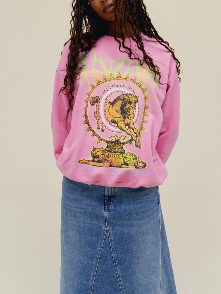 Day Dreamer The Doors Crewneck Pink Sugar. This boyfriend crewneck pays tribute to The Doors’ lasting legacy with 100% original artwork of a horse and tiger graphic mixed with psychedelic motifs in euphoric colors. Marked with a special shoutout to their studio album “Strange Days.”