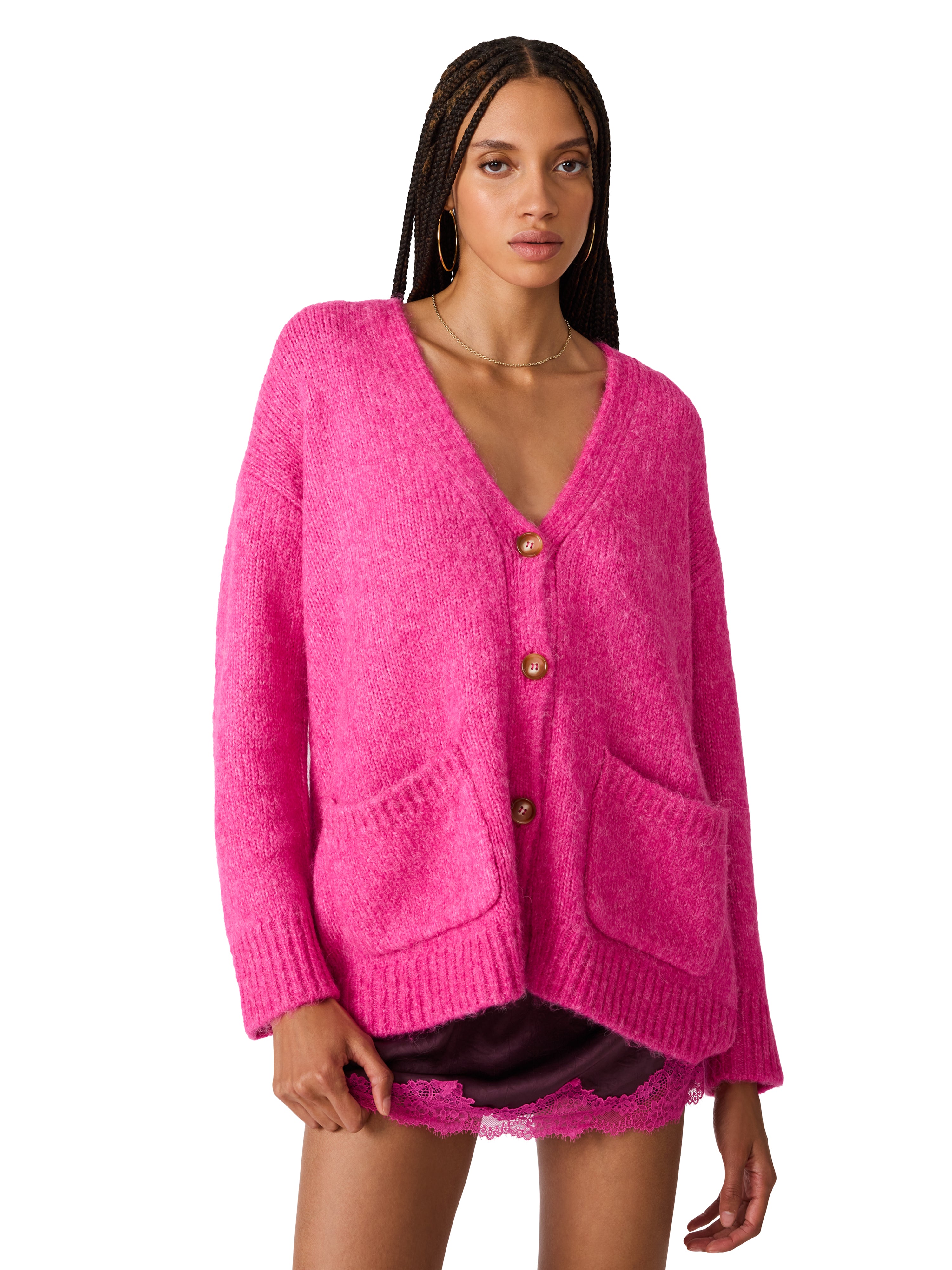 Model wearing an oversized fuzzy knit cardigan with front patch pockets, button-front closure, and a relaxed fit.