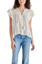 Steve Madden Bellamy Top Ivory. Set your boho spirit free in this breezy cotton top designed with eyelet-trimmed ruffles and a tassel-tie neck.
