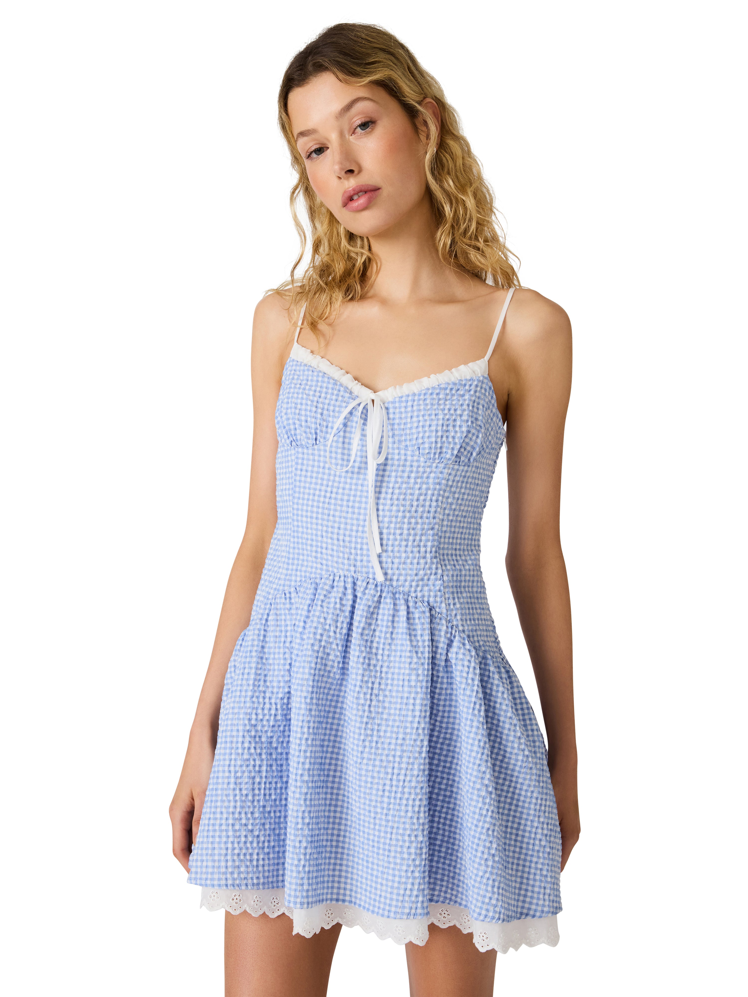 Gingham mini dress with thin straps, fitted bodice, tie detail, and flared skirt with trim hem