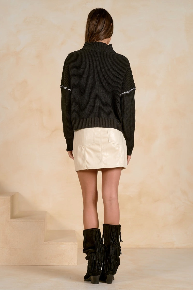 Back view of a quarter-zip sweater with contrast stitching detail.