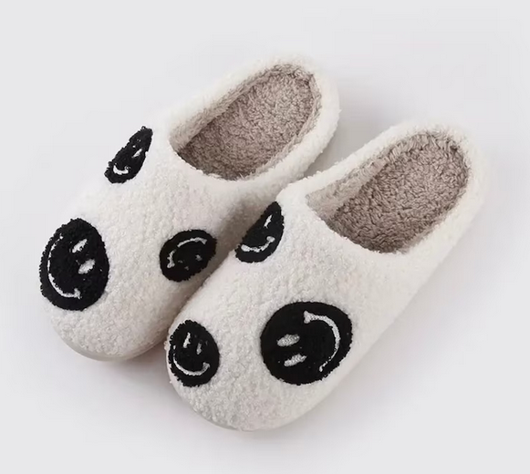 Stay cozy, stylish, and happy with these Multi Black Smiley Face Slippers from Whim! Perfect for weekends with the fam or working from home.