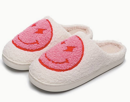 Bolt Eyes Smiley Face Slippers Pink Blue. Stay cozy, stylish, and happy with these Lightning bolt Eyes Smiley Face Slippers from Whim! Perfect for weekends with the fam or working from home.