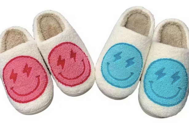 Bolt Eyes Smiley Face Slippers Pink Blue. Stay cozy, stylish, and happy with these Lightning bolt Eyes Smiley Face Slippers from Whim! Perfect for weekends with the fam or working from home.